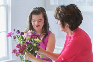 Girl arranging flowers with her grandmother