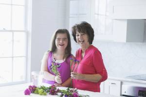 Girl with Down Syndrome and grandmother arranging flowers