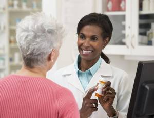 female pharmacist serving customer